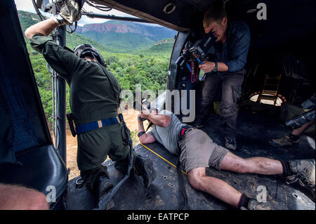 Photographer and cameraman film an airforce rescue crew in a flood. Stock Photo