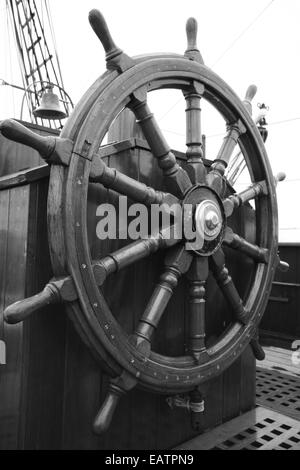 A black and white photograph of a ships wheel to steer the ship. Stock Photo