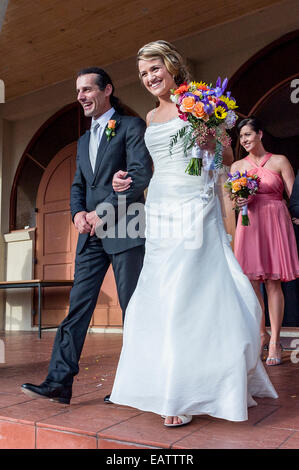 A bride and groom leave the church following a Greek Orthodox wedding. Stock Photo