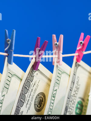 Hundred dollars hanging on clothesline. Money laundering concept Stock Photo