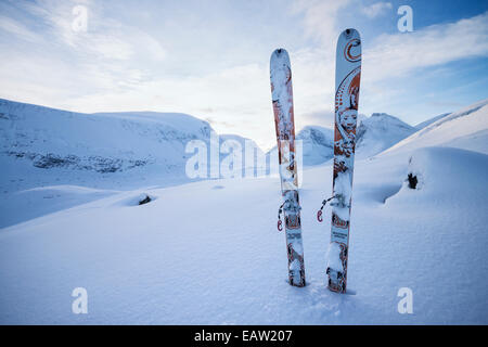 Set of Dynafit touring skis stuck in powder snow on mountain slope Lapland Sweden Stock Photo