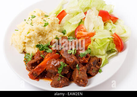 Beef in red sauce with a salad and mashed potato Stock Photo