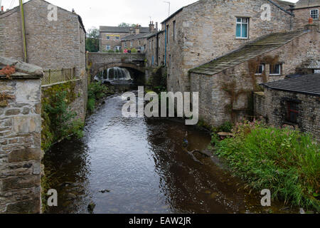 Bridge, falls and old mill, Hawes, Wensleydale in the Yorkshire Dales National Park with bunting to welcome the Tour de France Stock Photo