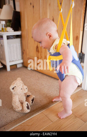 Baby in a door bouncer Stock Photo