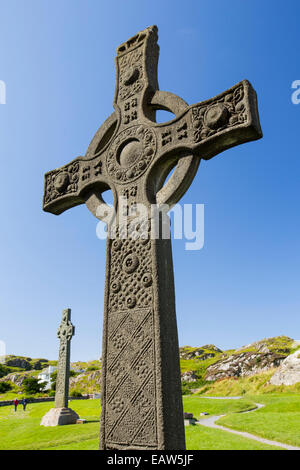 St John's Cross in the grounds of Iona Abbey, Iona, off mull, Scotland, UK, with St Oran's Cross in the background Stock Photo