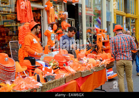 Vendors sell souvenirs and clothing in orange, the Dutch national color, for King's Day. Former Queen?s Day, held since 1890, became King?s Day, or Koningsdag this year. The change came last year after Queen Beatrix abdicated her post to her son Willem-Al Stock Photo