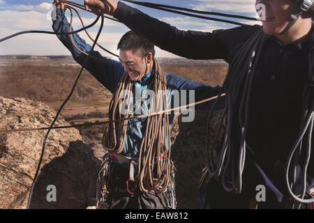 Two men coil rope after a climb at Garden of the Gods in Colorado Springs, Colorado. Stock Photo