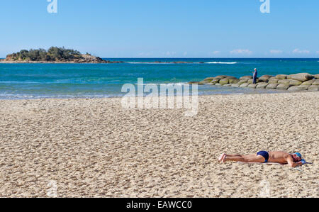 Sunbather on beach at mouth of Maroochy River, Sunshine Coast Queensland, Australia Stock Photo