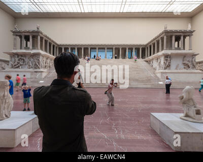 Visitors in Berlin's Pergamon museum in the grand hall with the famous Pergamon altar. Stock Photo