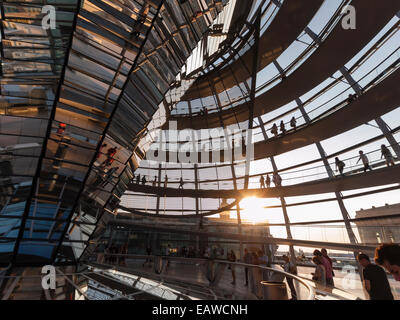 Visitors are gathering beneath the glass dome on top of Berlin Reichstag, the German house of  parliament. Stock Photo