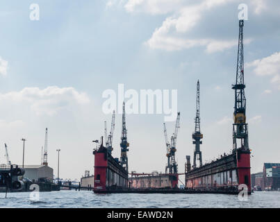 An empty dry dock of German shipbuilder 'Blohm+Voss' is floating on the Elbe river at Hamburg harbor. Stock Photo