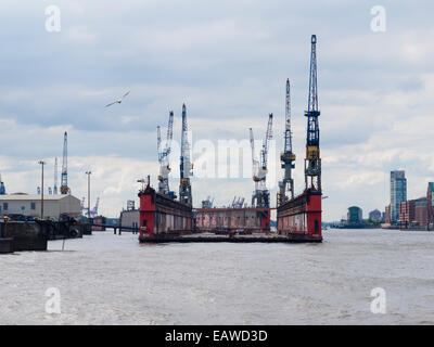 An empty dry dock of German shipbuilder 'Blohm+Voss' is floating on the Elbe river at Hamburg harbor. Stock Photo