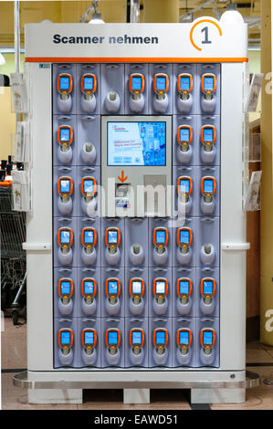 Rack with handheld Subito self-scanning devices in a Migros supermarket in Zurich, Switzerland. Stock Photo