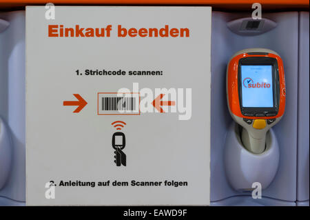 Self-service checkout at a Migros supermarket in Zurich, Switzerland. Text says "to finish shopping: scan this bar code" Stock Photo