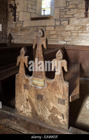 Pew bench ends labeled with local properties in St Marys church in the Cotswold village of Edgeworth, Gloucestershire UK - This Stock Photo