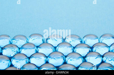 glass beads on blue background Stock Photo