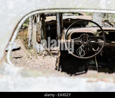 Broken steering wheel of a car seen through a side mirror Stock Photo