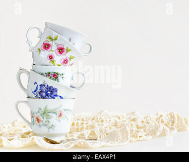 Stack of high tea cups on white Stock Photo