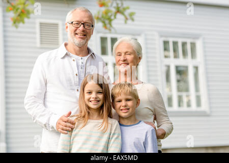 happy family in front of house outdoors Stock Photo