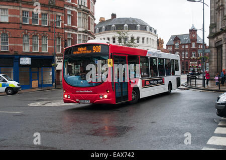 A National Express West Midlands Volvo B7RLE with Wrightbus bodywork passes through the center of Wolverhampton on a wet morning Stock Photo