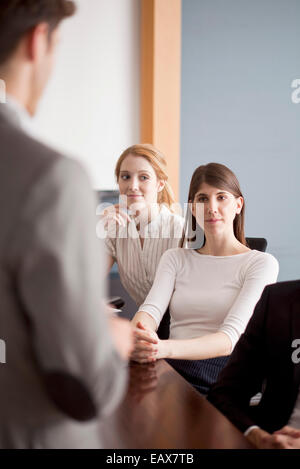 Business professionals attending presentation Stock Photo