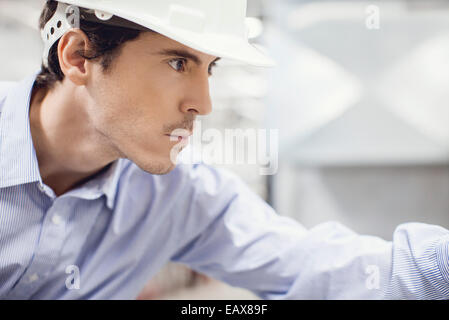 Technician working in industrial plant Stock Photo