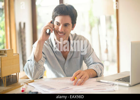 Office worker talking on cell phone Stock Photo