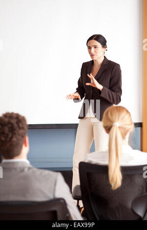 Businesswoman giving presentation Stock Photo