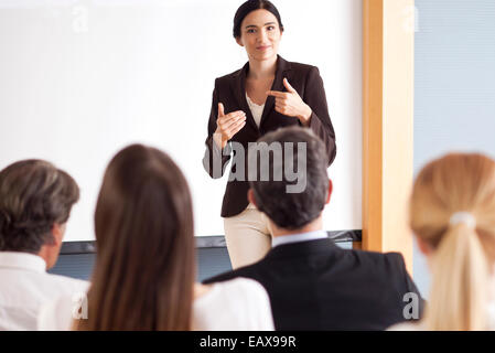 Businesswoman giving presentation at meeting Stock Photo