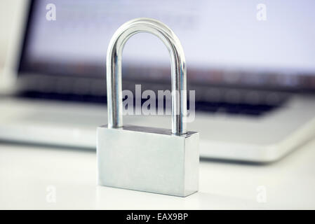 Padlock in front of laptop computer representing internet security Stock Photo