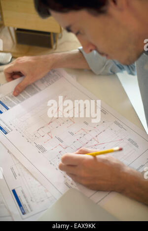 Architect examining blueprint Stock Photo