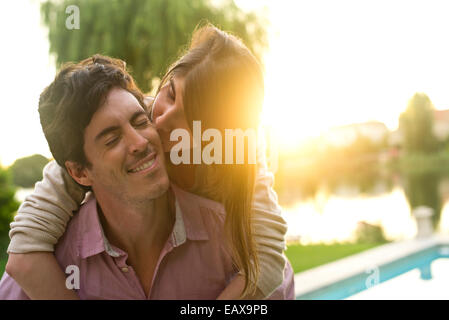 Woman kissing boyfriend on cheek Stock Photo