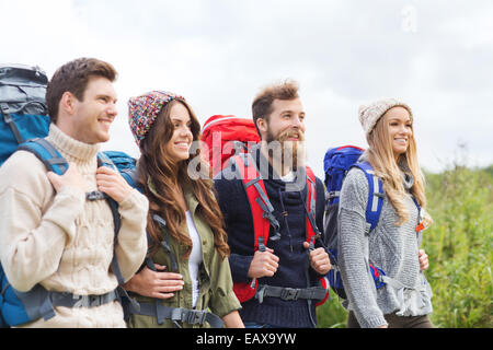 group of smiling friends with backpacks hiking Stock Photo - Alamy
