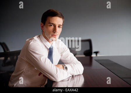 Businessman sitting at conference table, portrait Stock Photo