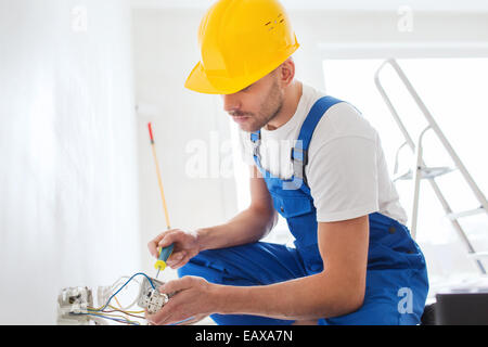builder with tablet pc and equipment indoors Stock Photo
