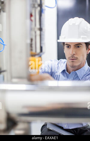 Engineer at work at industrial plant Stock Photo