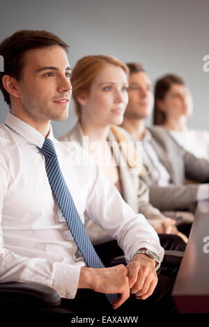 Young business professionals attending conference Stock Photo