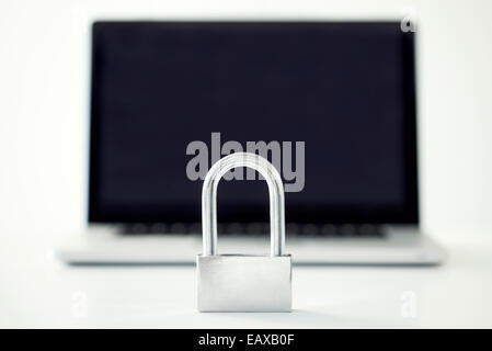 Padlock in front of laptop computer representing internet security Stock Photo
