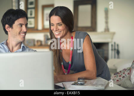 Couple using laptop computer at home Stock Photo