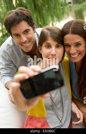 Young woman taking selfie with parents Stock Photo