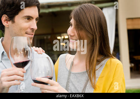 Couple clinking wine glasses Stock Photo