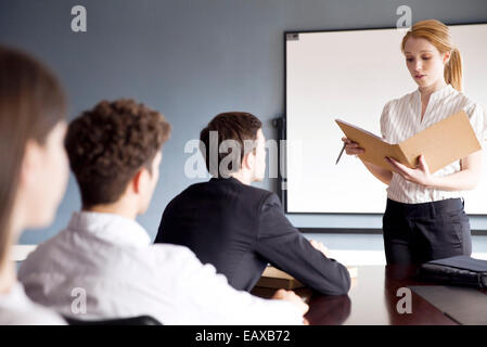 Businesswoman presenting report at corporate meeting Stock Photo