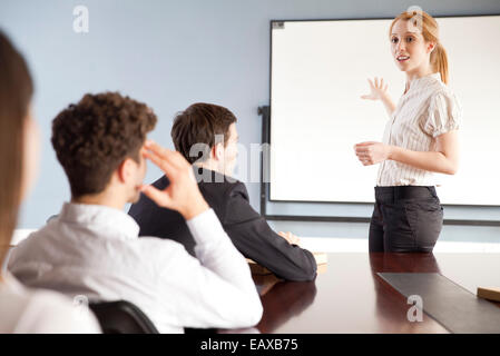 Businesswoman giving presentation at corporate meeting Stock Photo