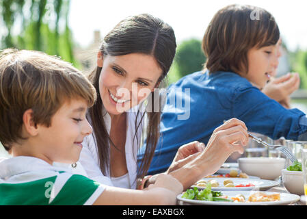Family enjoying healthy meal outdoors Stock Photo