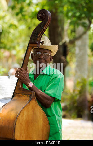 PINAR DEL RIO, CUBA - MAY 7, 2014: Old man plays the contrabass. Cuban music is an attraction for the over 2 million tourists wh Stock Photo
