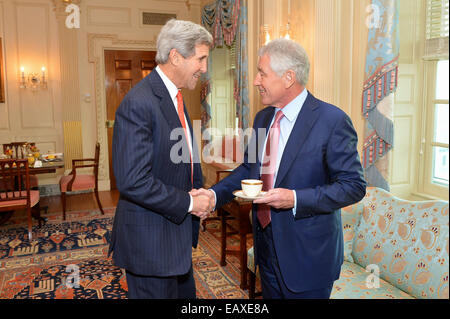 U.S. Secretary of State John Kerry greets U.S. Secretary of Defense Chuck Hagel before their meeting at the U.S. Department of State in Washington, D.C., on November 4, 2014. Stock Photo