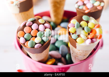 Sweet ice creams with colorful bonbons in the basket,selective focus Stock Photo