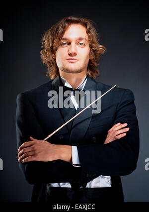 Portrait of a Young Conductor Holding a  Baton. Stock Photo