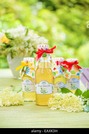 Bottles with elderflower syrup in the garden Stock Photo