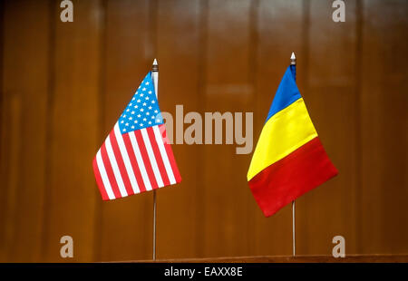 American and romanian table flags at a press conference Stock Photo